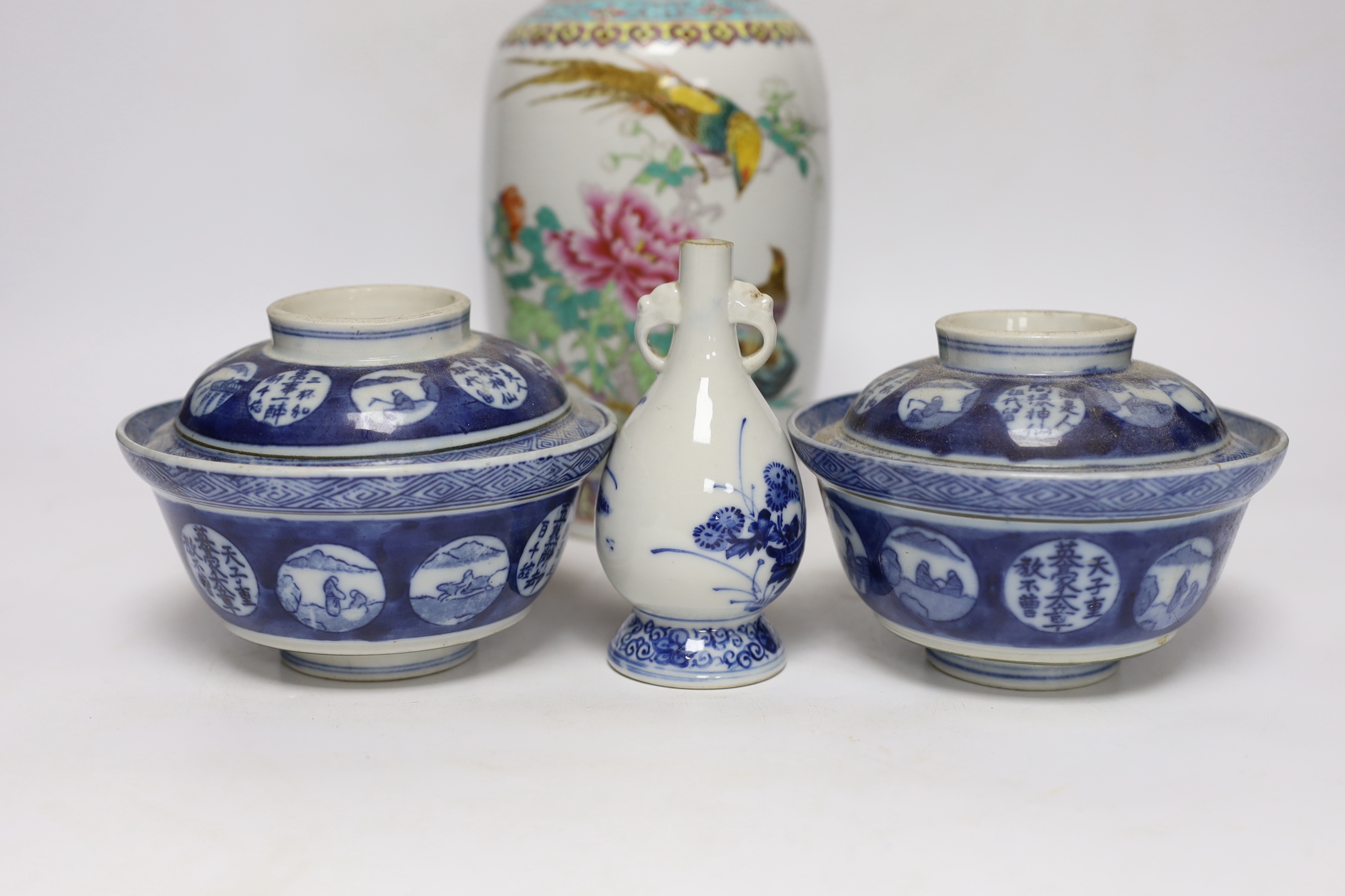 A Chinese famille rose vase, two Japanese blue and white rice bowls and covers and a Japanese blue and white vase (4) tallest 24.5cm
